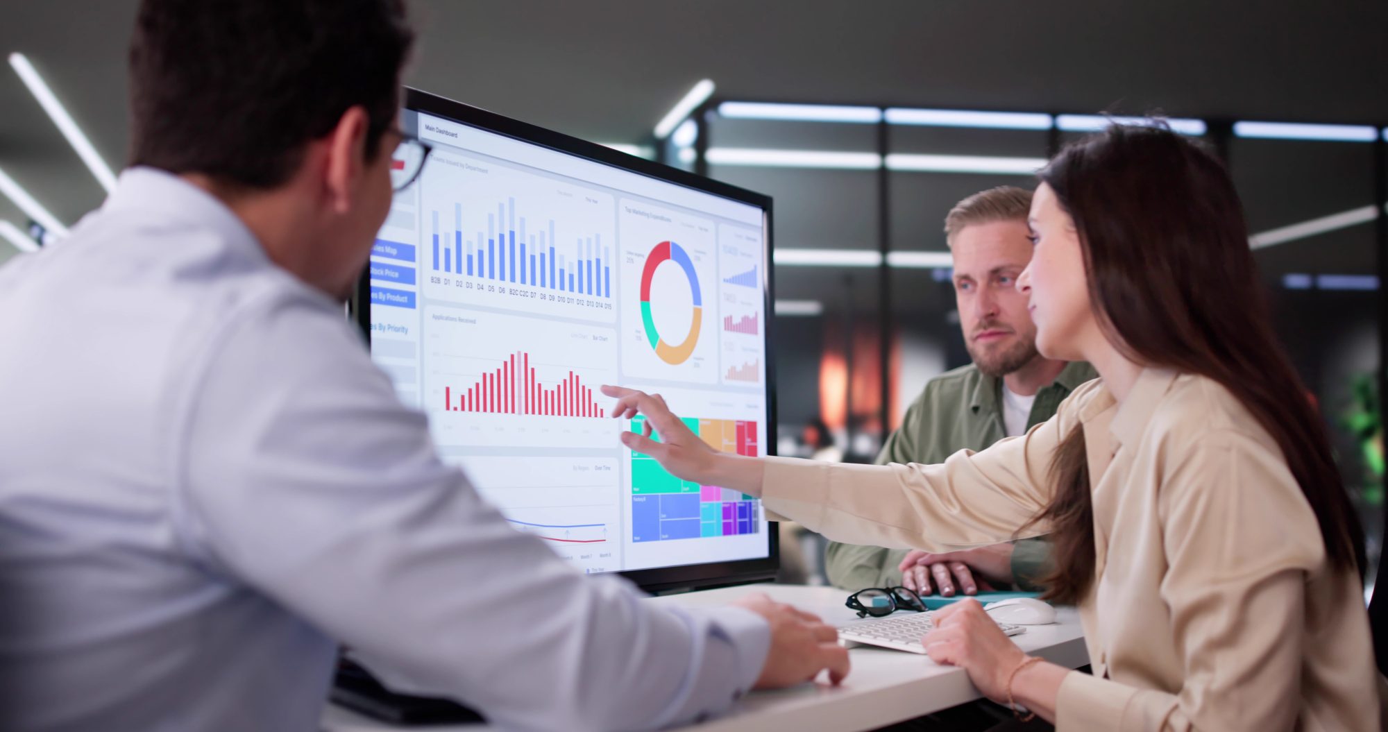 Small business team reviewing analytics dashboards to guide AI-driven growth and digital strategy.