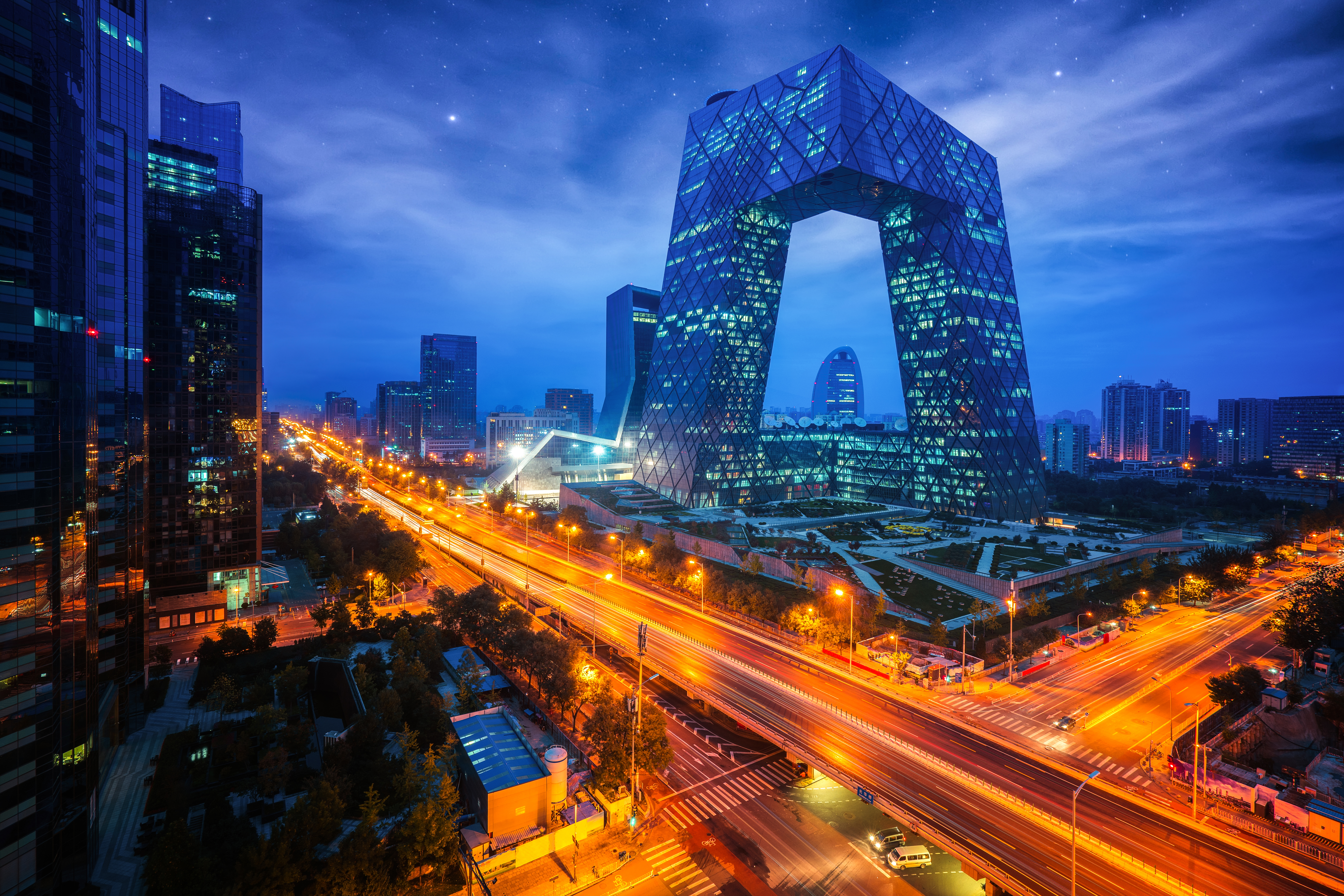 Beijing: Modern Beijing cityscape at night with CCTV headquarters and highway light trails Shanghai: Shanghai Pudong skyline at night featuring the Oriental Pearl Tower and Huangpu River
