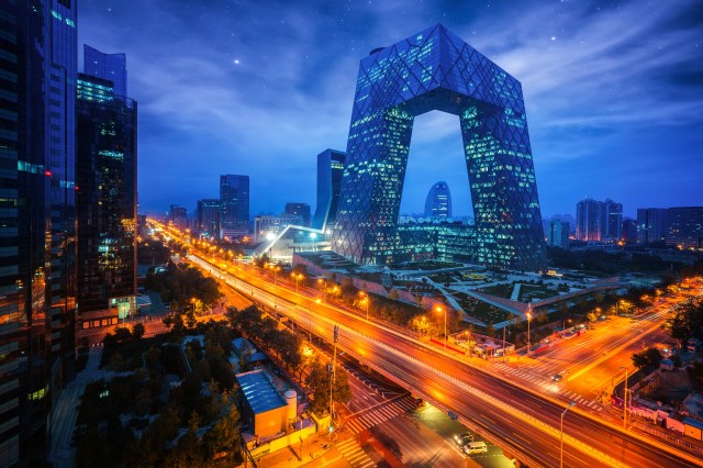 Beijing: Modern Beijing cityscape at night with CCTV headquarters and highway light trails Shanghai: Shanghai Pudong skyline at night featuring the Oriental Pearl Tower and Huangpu River
