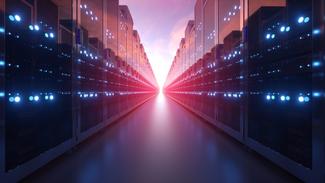 Rows of illuminated datacenter server racks stretching into the distance with blue and red lighting, representing AI infrastructure growth and enterprise Ethernet switching investment.