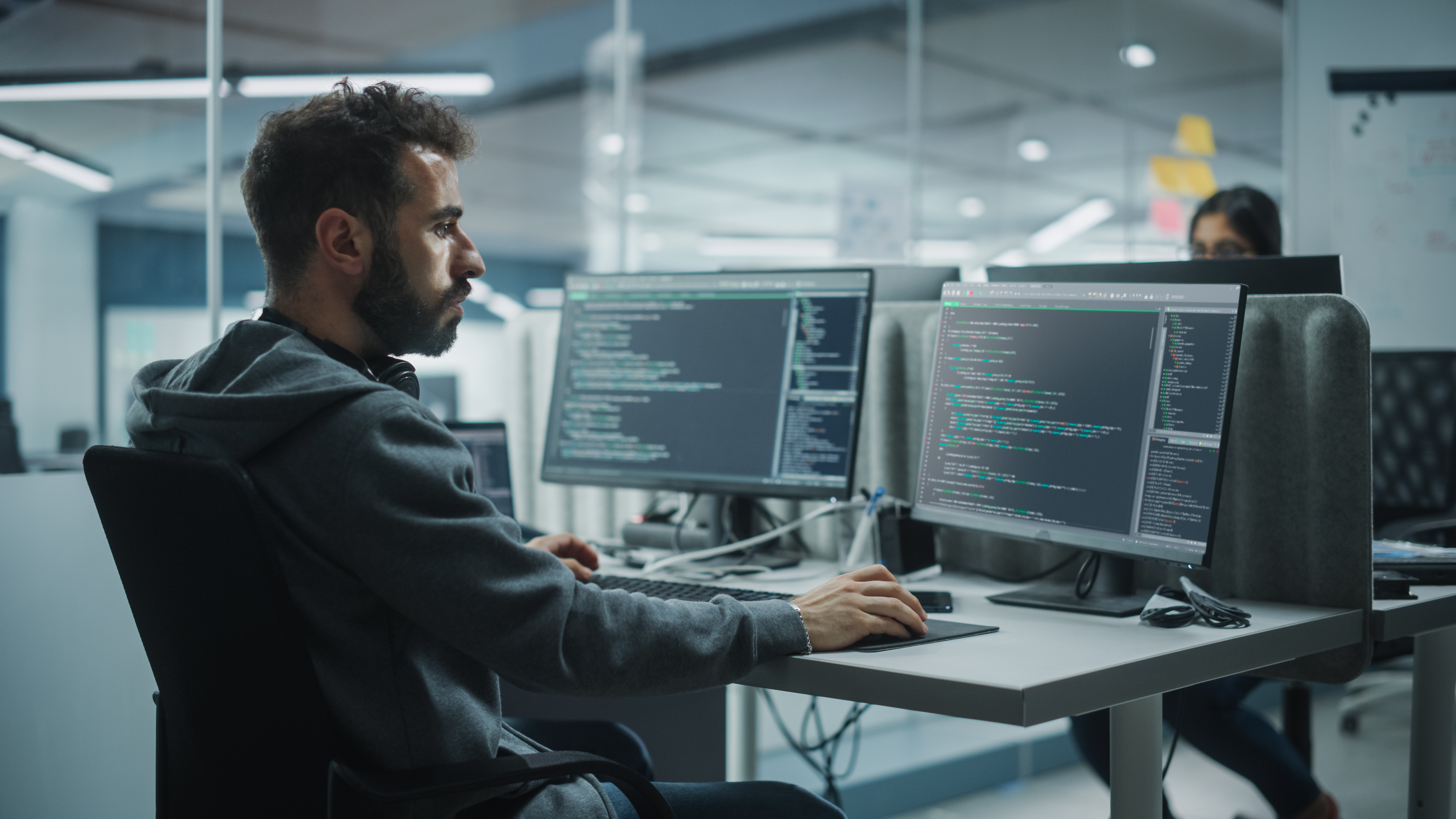 Software engineer working on code in an enterprise office environment