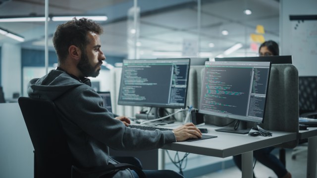 Software engineer working on code in an enterprise office environment
